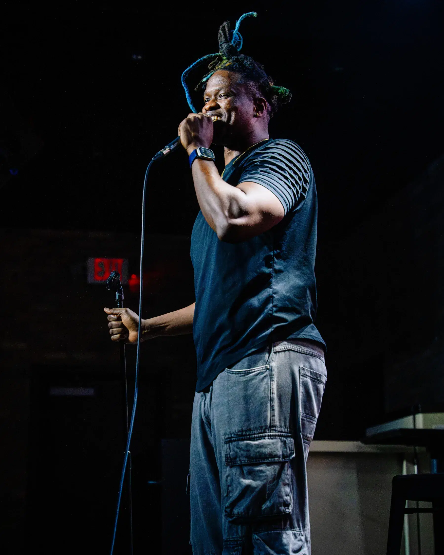 Fredo Louis performing stand-up comedy on stage